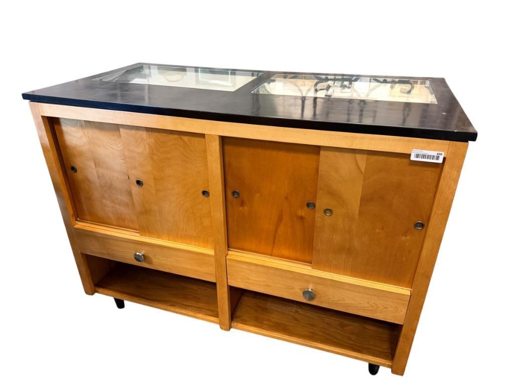 VINTAGE DEPARTMENT STORE DISPLAY CASE: WOOD BODY WITH GLASS FRONT WINDOWS, GLASS TOP INSERTS AND GLASS SHELVES, FEATURES CUBBIES AND DRAWERS FOR STORAGE, AND TAPERED METAL LEGS, COMPLETE, DOES SHOW SIGNS OF USE 48" X 24" X 36"