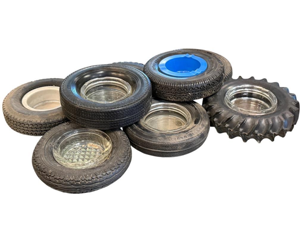 EIGHT VINTAGE AUTOMOTIVE SHOP RUBBER TIRE ADVERTISMENT ASHTRAYS WITH GLASS LINERS: INCLUDES DUNLOP, PIRELLI, GOODYEAR, FIRESTONE, AND OTHERS, ALL WITH GLASS LINERS, GOODYEAR ASHTRAY IS HEAVILY WORN 5 1/4" UP TO 6 1/4" ROUND