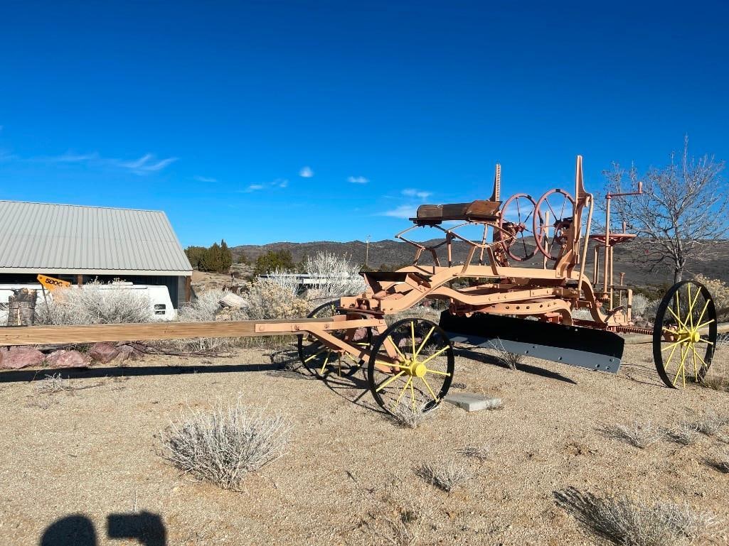 THE GALION IRONWORKS ANTIQUE HORSE-DRAWN GRADER EARLY CONSTRUCTION EQUIPMENT: MADE IN THE EARLY 20TH CENTURY USED TO SMOOTH DIRT ROADS OR CONSTRUCT DRAINAGE DITCHES, FEATURES STEEL WHEELS WITH LEAF SPRING DRIVERS SEAT, REAR WOODEN PLATFORM, STEEL WHEELS, ORIGINAL MANUFACTURE