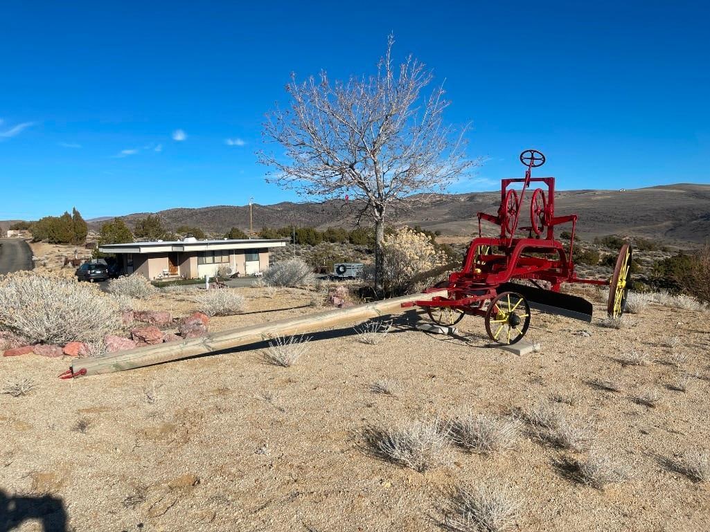 ANTIQUE HORSE-DRAWN GRADER EARLY CONSTRUCTION EQUIPMENT: FEATURES WOODEN PLATFORM FOR WORKER TO OPERATE BLADE AND GUIDE HORSES, VARIOUS WHEELS TO OPERATE BLADE, NO MANUFACTURE LABEL, HAS BEEN PREVIOUSLY REPAINTED 18' OVERALL LENGTH, 17" AND 35" WHEELS, 71"
