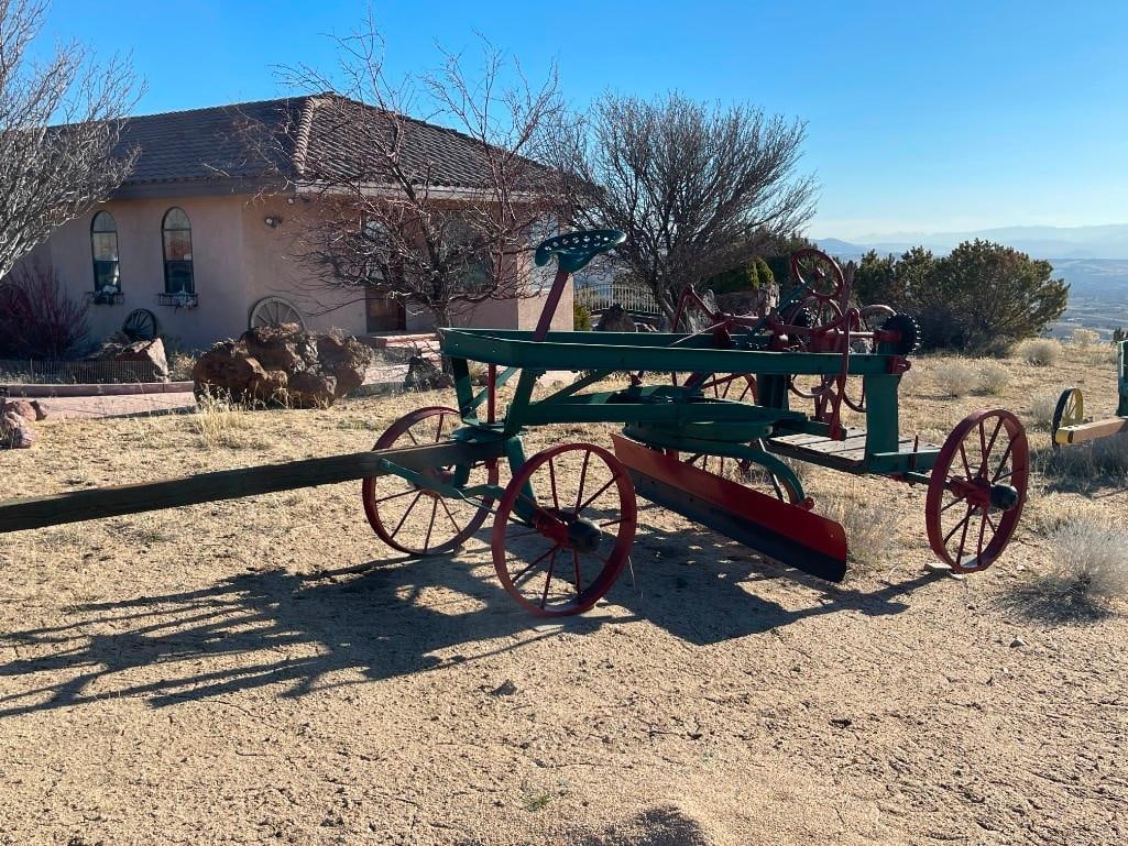 ANTIQUE THE RUSSELL JR. HORSE-DRAWN ROAD GRADER MFD. BY THE RUSSELL GRADER MFG. CO. EARLY 2OTH C.: EARLY ROAD GRADER CONSTRUCTION EQUIPMENT USED TO PLOW AND MAINTAIN ROADS, FEATURES WOODEN PLATFORM FOR PERSON OPERATING BLADE AND SEAT FOR GUIDING HORSES, GEARS ARE MARKED BY THE MANUFACTURE, HAS BEEN