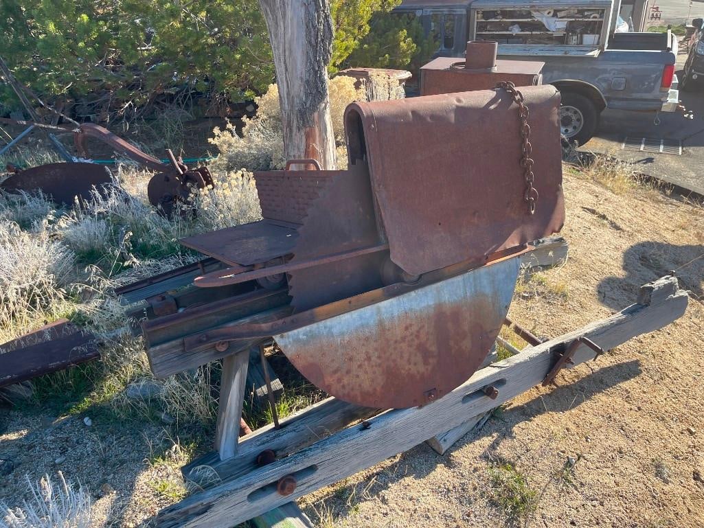 ANTIQUE FARMING IMPLEMENT BUZZ SAW YARD ART: FEATURING MASSIVE BLADE WITH SLIDE FUNCTION MOUNTED TO WOODEN SLABS 30" SAW BLADE, 36" X 90" X 44" TOTAL DIMENSIONS
