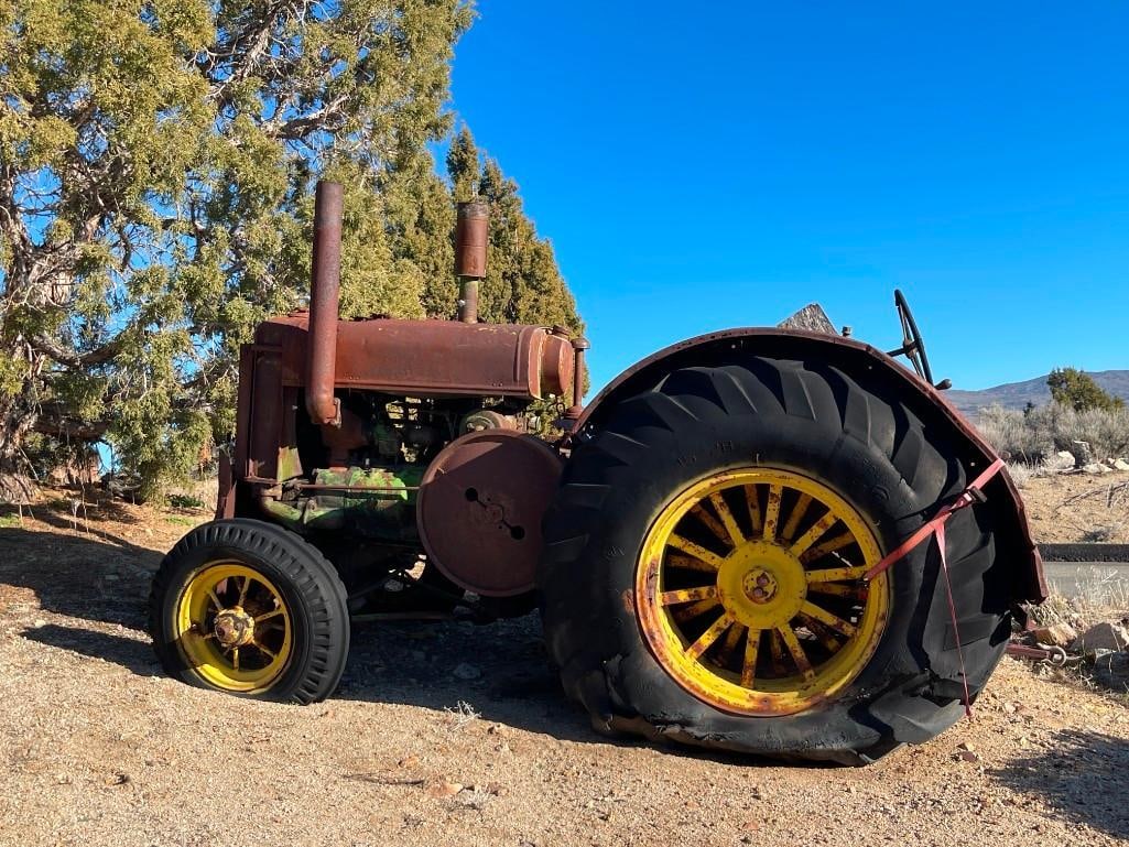 ANTIQUE JOHN DEERE MODEL D TRACTOR: FRONT GRILL MARKED JOHN DEERE, STILL HAS SOME OF THE CLASSIC GREEN AND YELLOW JOHN DEERE PAINT, MARKED "D55R," AND "D831R," RUSTED FROM WEATHER, YARD ART, FIRESTONE BACK TIRES, HAS JOHN DEERE METAL LA