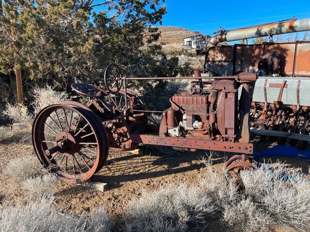 ANTIQUE INTERNATIONAL HARVESTER MCCORMACK DEERING MODEL F-12 TRACTOR: WITH TRACTOR SEAT STILL IN TACT, INCLUDES MARKER'S LABEL, SERIAL # FS86904, ENGINE BLOCK MARKED 4818D, RUSTED FROM WEATHER, YARD ART 38" BACK TIRE RIMS, 108" X 53" X 57"