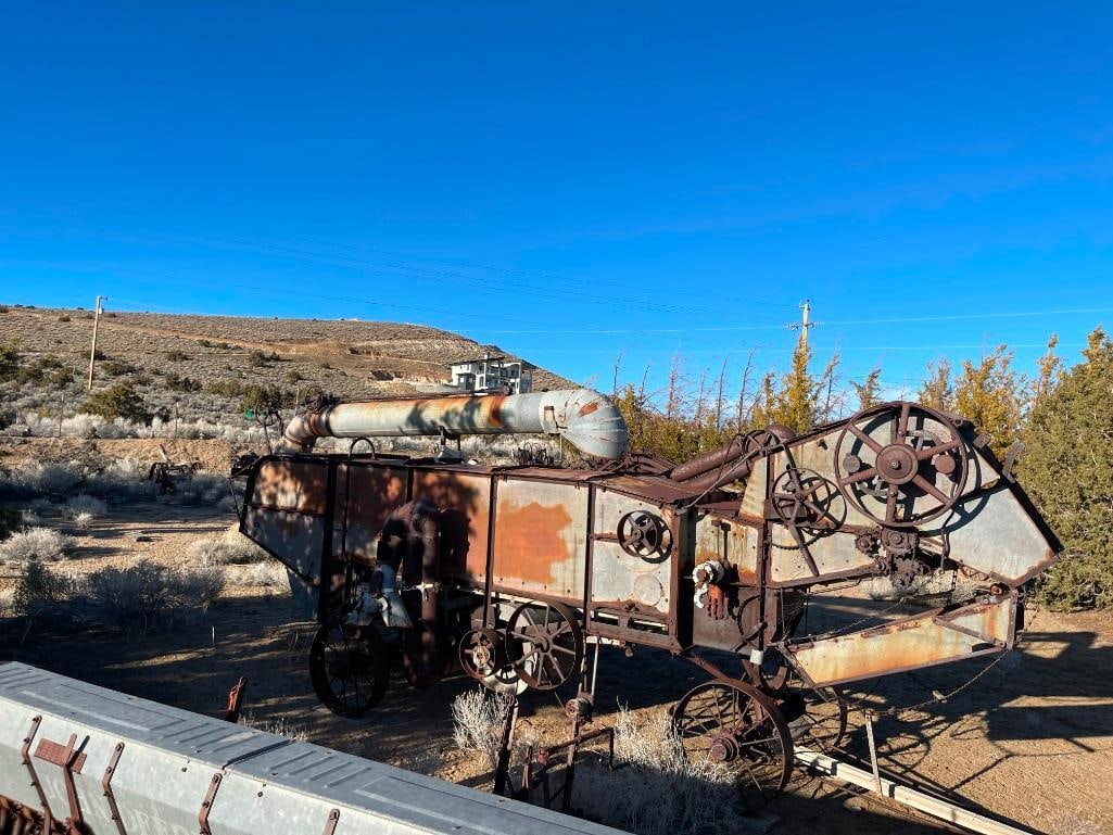 ANTIQUE FARMING IMPLEMENT THRESHING MACHINE: USED TO SEPARATE GRAIN FROM STRAW, PREDECESSOR TO MODERN COMBINES, PATENT DATE OF JAN. 1900, RUSTED FROM WEATHER, YARD ART