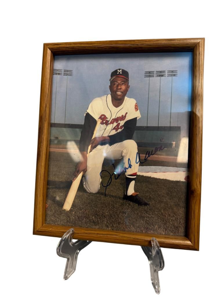 LEGENDARY BASEBALL PLAYER HANK AARON HALL OF FAMER AUTOGRAPHED / SIGNED PHOTOGRAPH: PHOTOGRAPH SHOWS HANK AARON KNEELING WITH BAT IN BRAVES UNIFORM, SIGNED IN BLUE INK, FROM THE ESTATE OF A LOCAL RENO, NV DOCTOR AT RENOWN WHO RAN BIG LEAGUE SPORTS MEDICINE BASEBALL CAMP FOR
