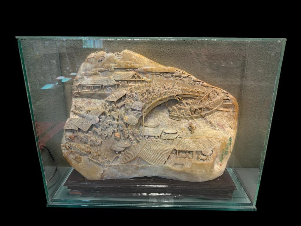 CHINESE SHOUSHAN STONE CARVING ALONG THE RIVER DURING QINGMING FESTIVAL DOUBLE-SIDED AFTER ZEDUAN: INTRICATELY CARVED LANDSCAPE WITH DETAILED FIGURES WALKING OVER A BRIDGE WITH BUILDINGS ALONG THE TOP AND BOTTOM, ASWELL AS PEOPLE IN A BOAT NEAR BRIDGE, CAPTURES DAILY LIFE OF PEOPLE FROM THE SONG
