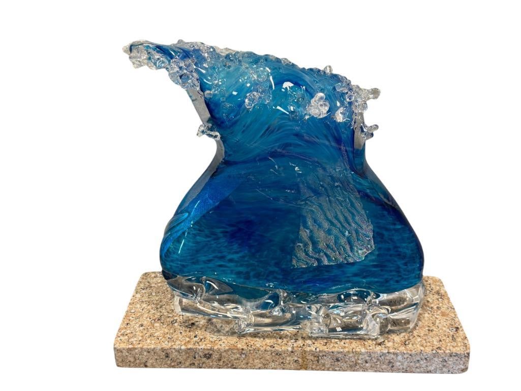 LARGE MAUI WAVE HAND BLOWN ART GLASS WAVE CENTERPIECE WITH IRIDESCENT DESIGN: ART GLASS CENTER PIECE OF A WAVE MOUNTED ON STONE BASE, FEATURES BLUE AND IRIDESCENT SHIMMER, TOP OF WAVE HAS TWO DAMAGED PIECES, NOT NOTICEABLE DUE TO DESIGN, OVERALL AN EYE-CATCHING PIECE 14" H
