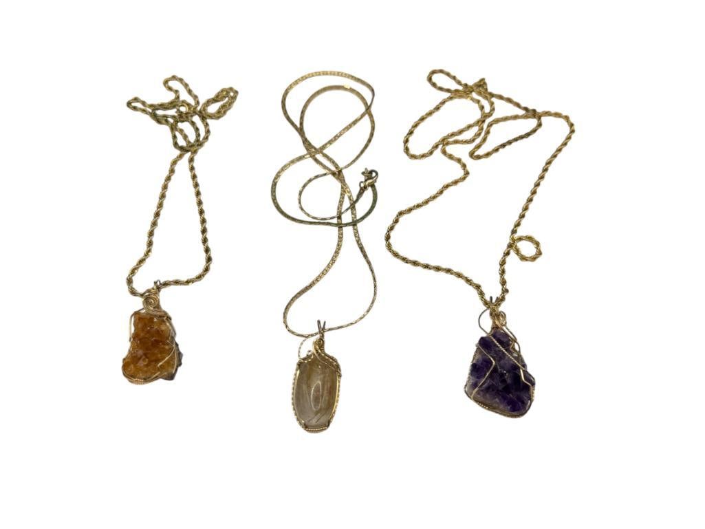 THREE GOLD TONE NECKLACES AWITH STONE PENDANTS INCLUDING AMETHYTS CLUSTER: ALSO INCLUDES CITRINE CLUSTER AND RUTILATED QUARTZ, ALL PENDANTS ARE WRAPPED IN GOLD TONE WIRE SETTINGS VARIOUS LENGTHS, UP TO 1 7/8" PENDANTS