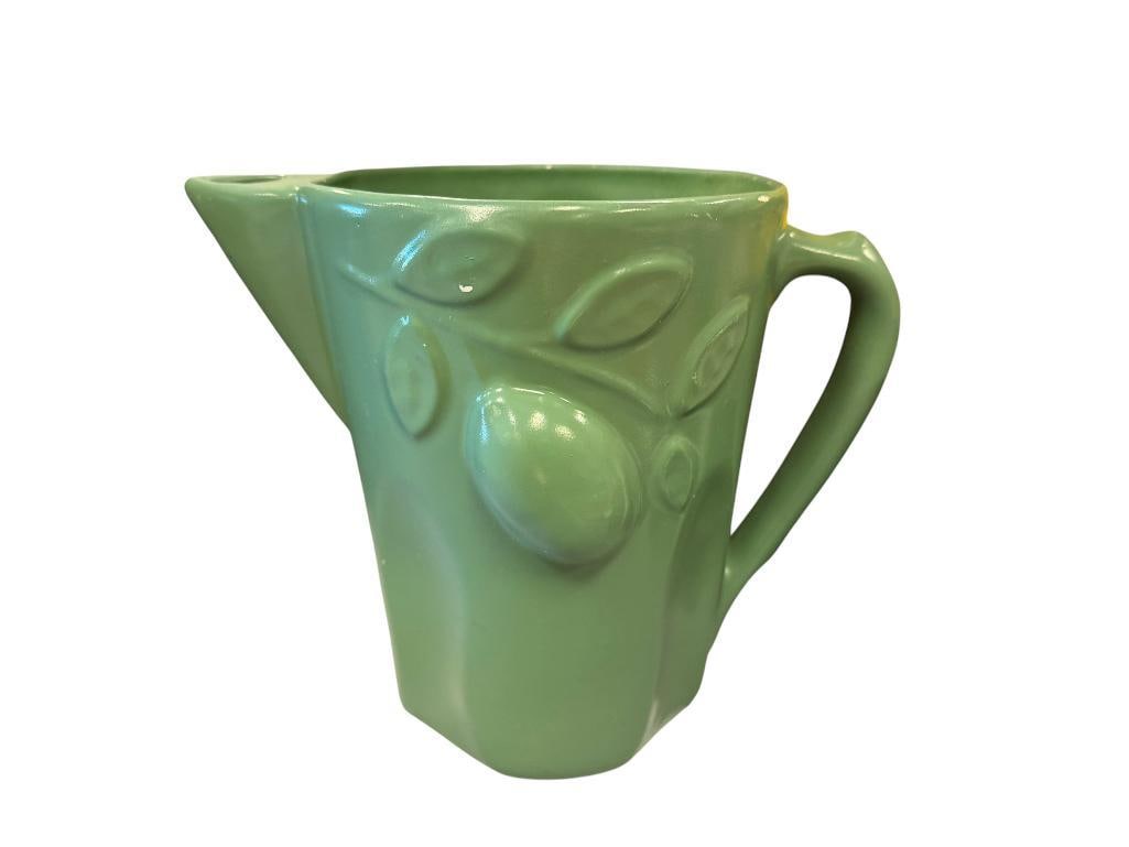 U.S.A. CALIFORNIA MID-CENTURY POTTERY GREEN GLAZED PITCHER: FRUIT MOTIF IN RELIEF, MARKED ON THE BOTTOM, LIGHT SCRATCHES TO GLAZE 8" H
