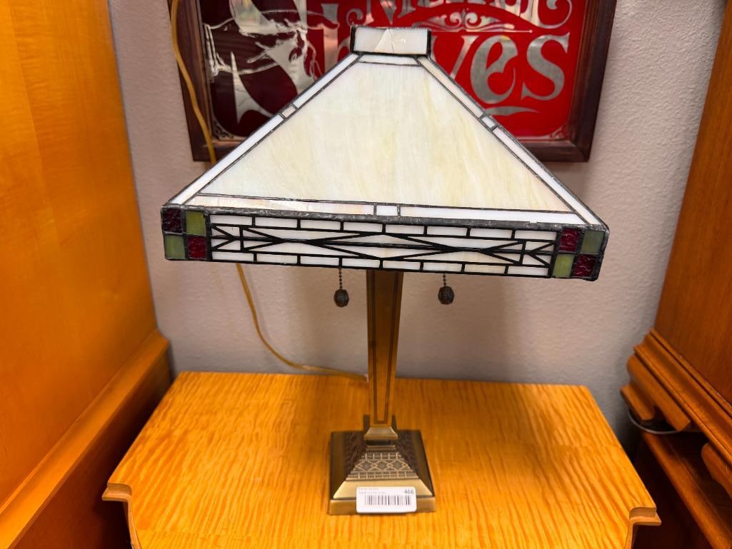 TIFFANY STYLE STAINED GLASS ACCENT TABLE LAMP ART DECO STYLED: GEOMETRIC DESIGN BRASS FINISH METAL BASE WITH STAINED GLASS SHADE FEATURING A GEOMETRIC METAL OVERLAY DESIGN, SHADE DOES HAVE SOME DAMAGE ALONG THE TOP, TESTED + 20" H