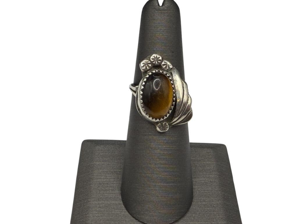 VINTAGE NAVAJO ARTIST SIGNED J. YAZZIE TIGER'S EYE RING: FEATURING AN OVAL CABOCHON TIGER'S EYE, SIGNED BY FAMED NAVAJO JEWELRY MAKING FAMILY ARTIST SIZE 6 1/4, 1" FRONT, 4.79 GRAMS