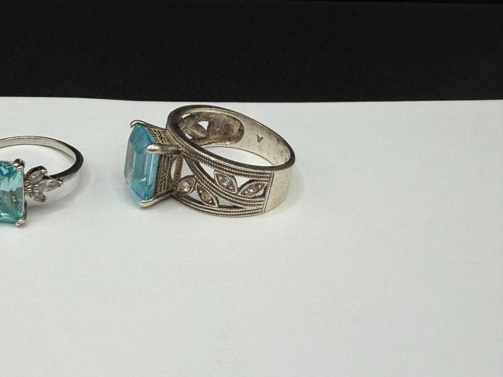 FOUR STERLING SILVER RINGS INCLUDING ONE WITH EMERALD CUT BLUE TOPAZ - 3