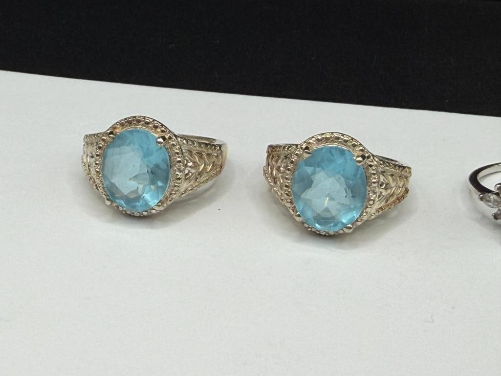 FOUR STERLING SILVER RINGS INCLUDING ONE WITH EMERALD CUT BLUE TOPAZ - 6