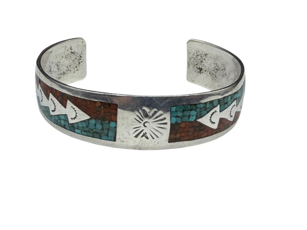 VINTAGE NAVAJO SAND CAST STERLING SILVER TURQUOISE AND CORAL CRUSHED INLAY DESIGN CUFF BRACELET: SIGNED BY ARTIST "JT," STAMPED ARROW DESIGN WITH INLAY 2 3/8" CUFF WRIST WIDTH X 5/8", 20.85 GRAMS