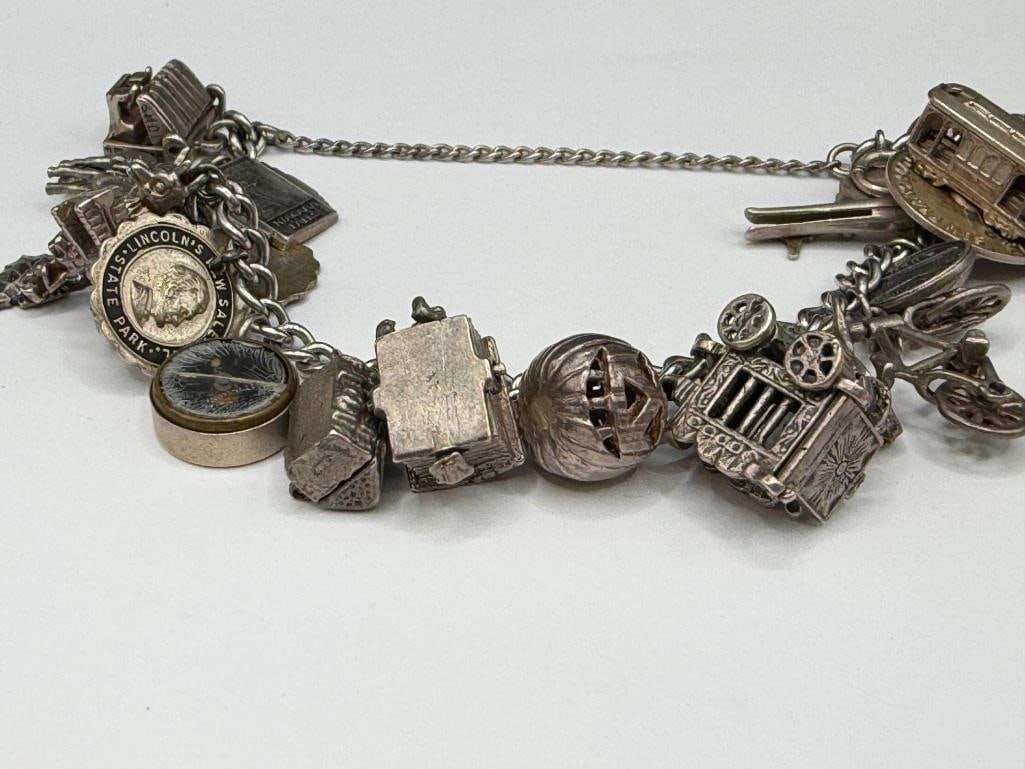 VINTAGE STERLING SILVER CHARM BRACELET FEATURING DOZENS OF STERLING SILVER CHARMS - 2