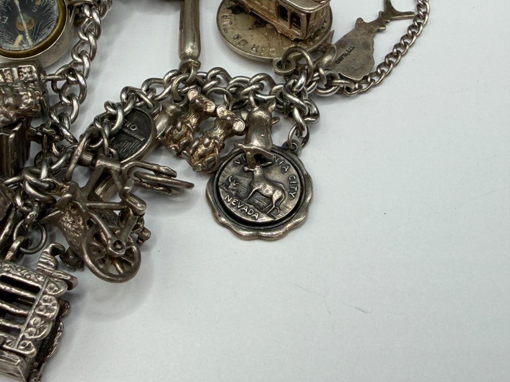 VINTAGE STERLING SILVER CHARM BRACELET FEATURING DOZENS OF STERLING SILVER CHARMS - 4