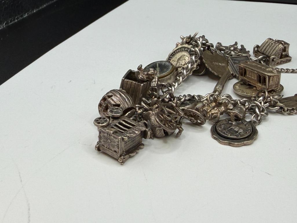 VINTAGE STERLING SILVER CHARM BRACELET FEATURING DOZENS OF STERLING SILVER CHARMS - 5