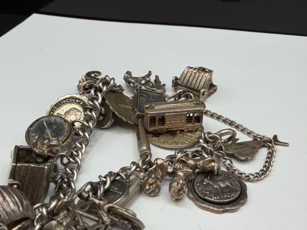 VINTAGE STERLING SILVER CHARM BRACELET FEATURING DOZENS OF STERLING SILVER CHARMS - 6
