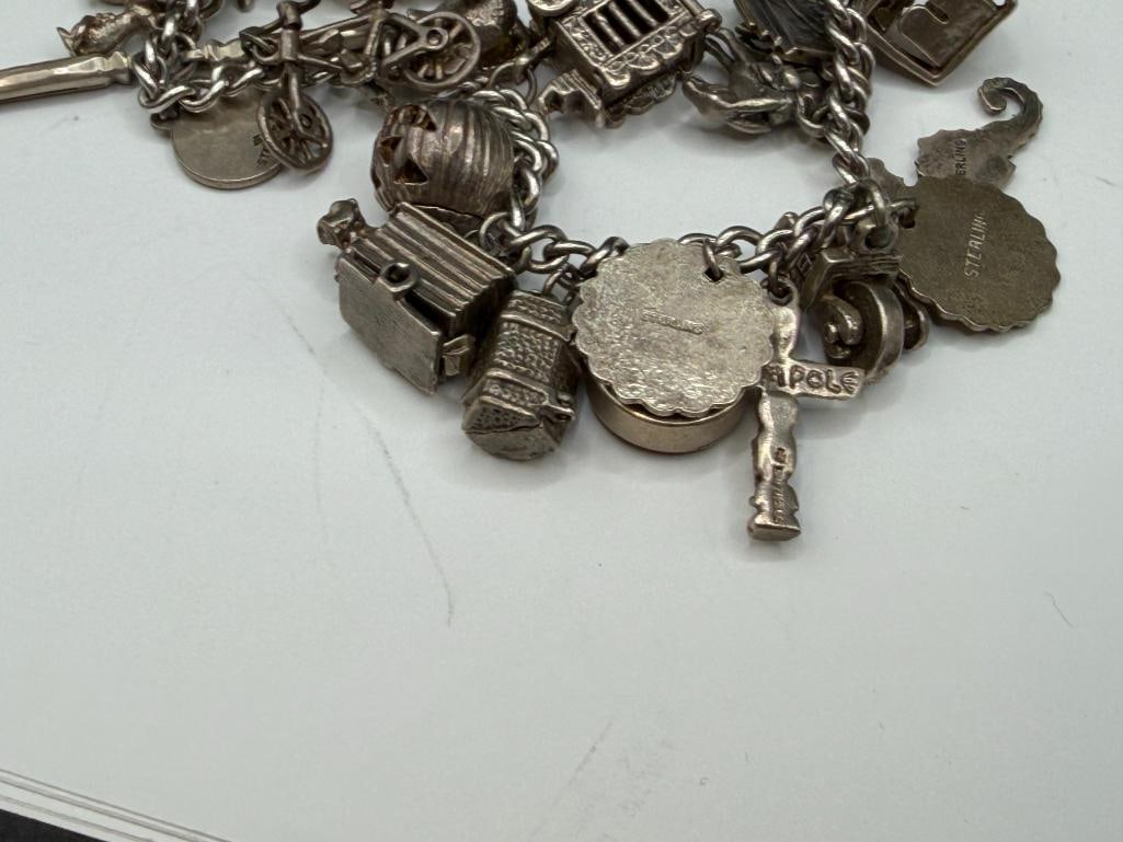 VINTAGE STERLING SILVER CHARM BRACELET FEATURING DOZENS OF STERLING SILVER CHARMS - 7