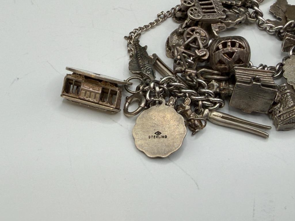 VINTAGE STERLING SILVER CHARM BRACELET FEATURING DOZENS OF STERLING SILVER CHARMS - 8