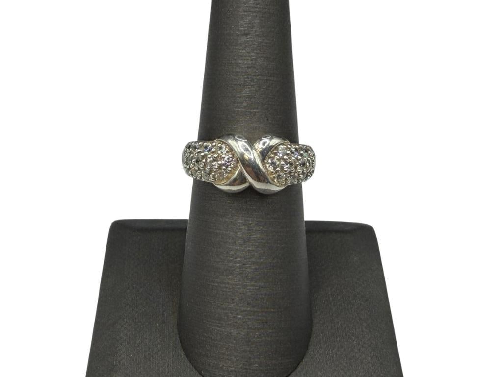 STERLING SILVER ROUND CUT CZ FASHION RING WITH "X" RIBBON DESIGN IN CENTER: PAVED WITH ROUND CUT CZ'S, MARKED CHINA WITH HALLMARK SIZE 7, 3/16" FRONT, 4.63 GRAMS