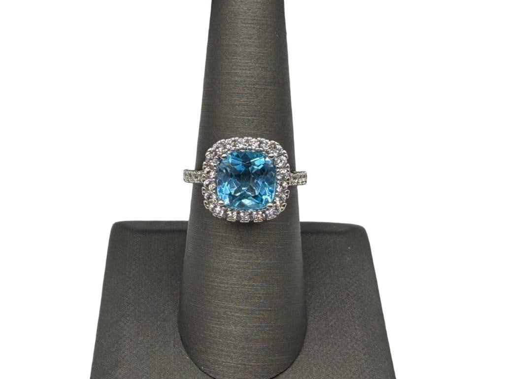 STERLING SILVER CUSHION CUT BLUE TOPAZ AND DIAMOND FASHION RING: FEATURES CUSHION CUT BLUE TOPAZ IN CENTER ACCENTED BY APPROX. 30 ROUND BRILLIANT CUT DIAMONDS, DESIGNER HALLMARKED "SUN" SIZE 7, 9/16' FRONT, 4.14 GRAMS