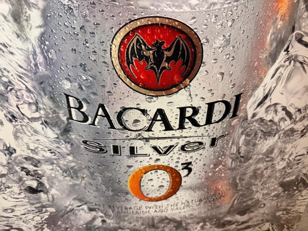 THREE BEER SIGNS INCLUDING FOSTERS TIN SIGN, BACARDI SILVER TIN SIGN, AND VINTAGE RHEINGOLD LAGER - 9