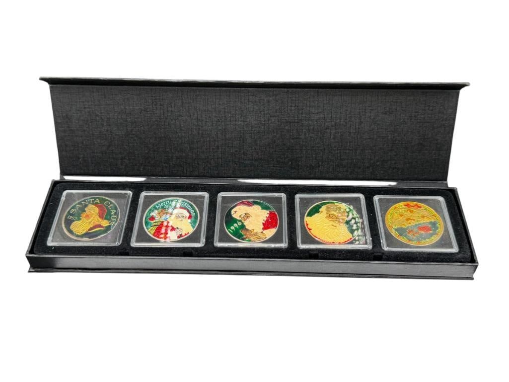 FIVE CHRISTMAS THEMED HOLIDAY SANTA CLAUS .999 FINE SILVER ENAMELED ROUNDS: FEATURES VARIOUS YEARS FROM THE 1990'S AND DIFFERENT DESIGNS ON EACH ROUND, IN CASE 1 TROY OUNCE EACH