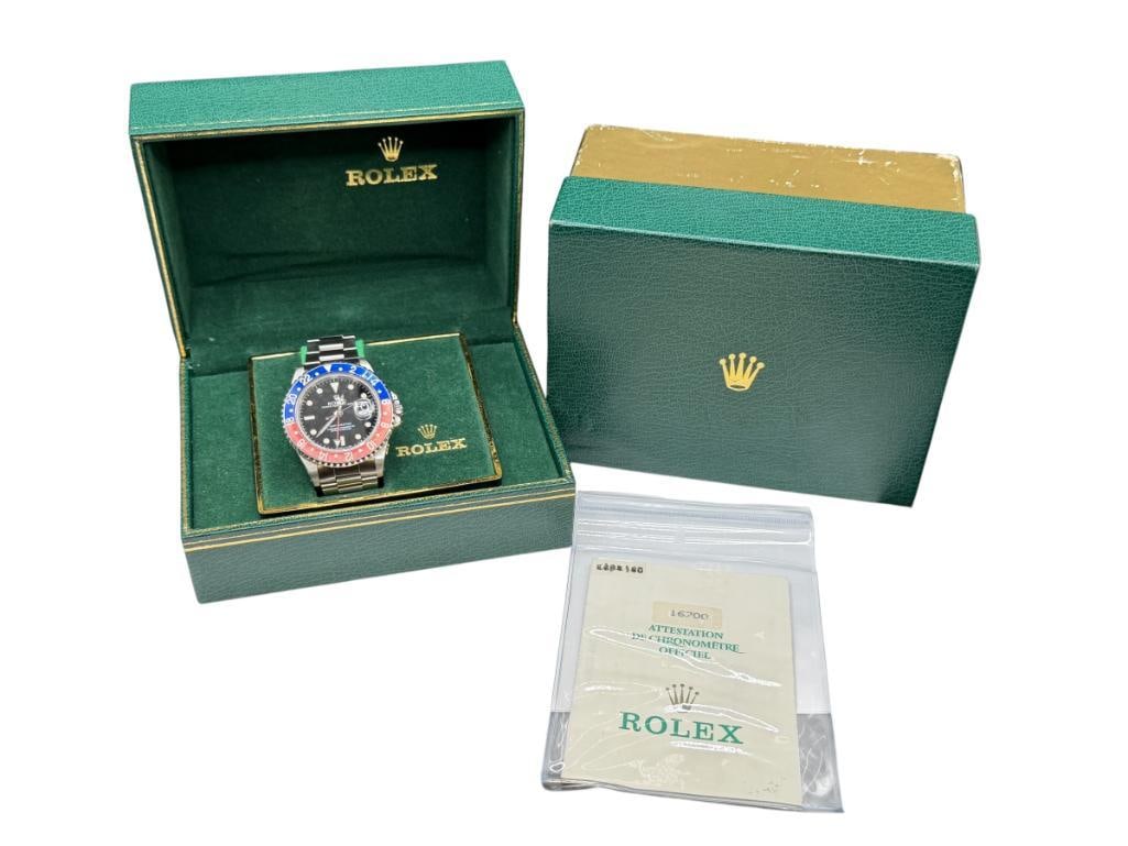 1990 ROLEX GMT MASTER PEPSI DIAL WRISTWATCH: INCLUDES BOX AND PAPERS, SERIAL # E808180, 400 CHRONOMETER, OFFICIALLY CERTIFIED, IN RUNNING CONDITION, GOOD CONDITION, STEELINOX STAINLESS STEEL BAND 40MM CASE