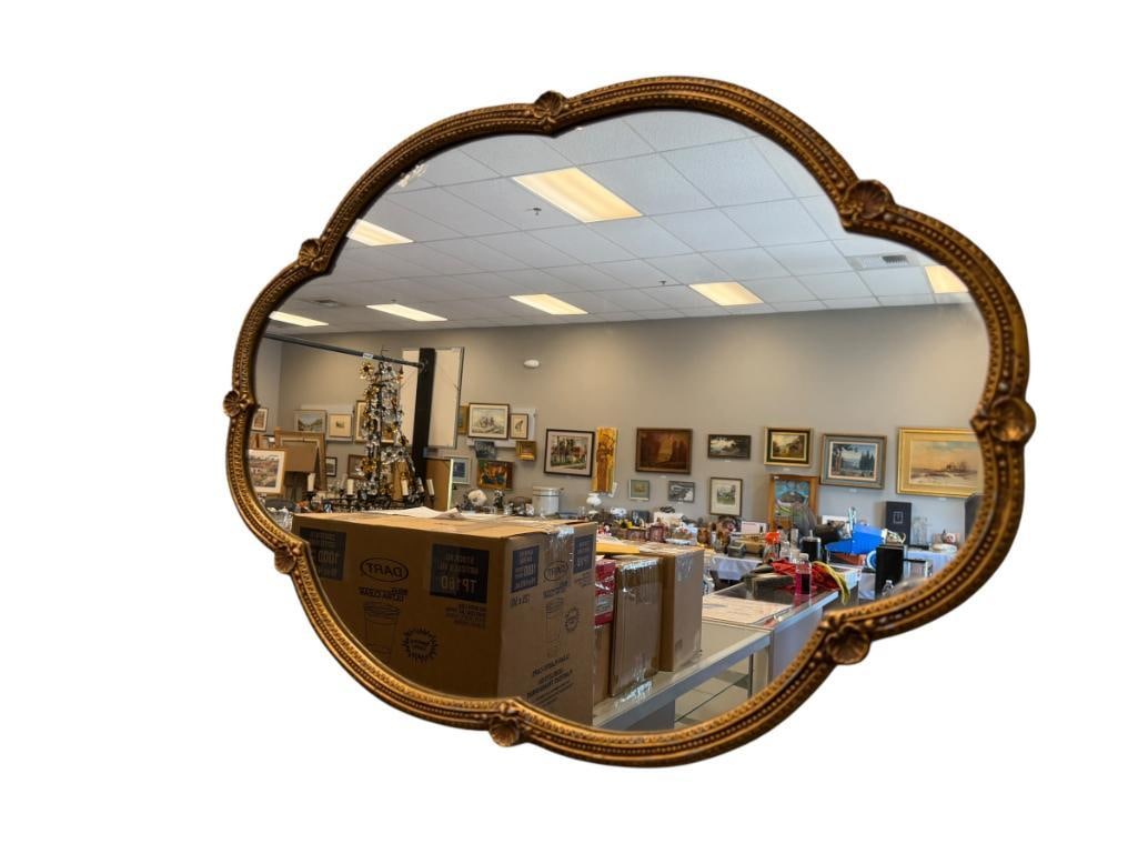 VINTAGE SCALLOPED EDGE GILT METAL FRAMED MIRROR: MIRROR HAS CHIPS IN A FEW AREAS 24" X 18" FRAME 