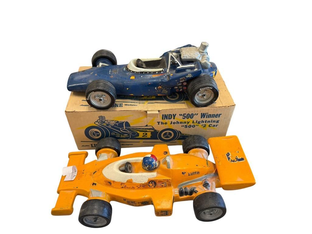 1974 HOFFMAN JOHNNY RUTHERFORD #3 MCLAREN 500 INDY CAR AND THE JOHNNY LIGHTNING INDY CAR DECANTERS: BOTH DECANTERS SHOW HEAVY WEAR TO DECALS, ONE INCLUDES THE ORIGINAL BOX 15" L