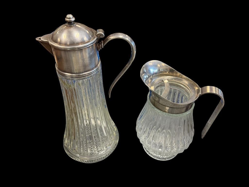 VINTAGE ITALIAN MADE GLASS WATER PITCHER AND WINE CLARET / ICED TEA CARAFE: BOTH ARE GLASS WITH SILVERPLATED SPOUTS, BOTH MARKED ITALY, NO CHIPS OR CRACKS LARGEST IS 13 1/2" H