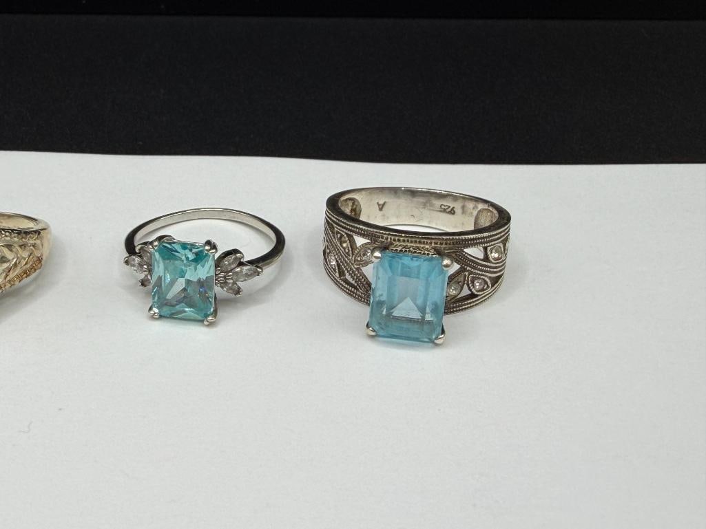 FOUR STERLING SILVER RINGS INCLUDING ONE WITH EMERALD CUT BLUE TOPAZ - 2