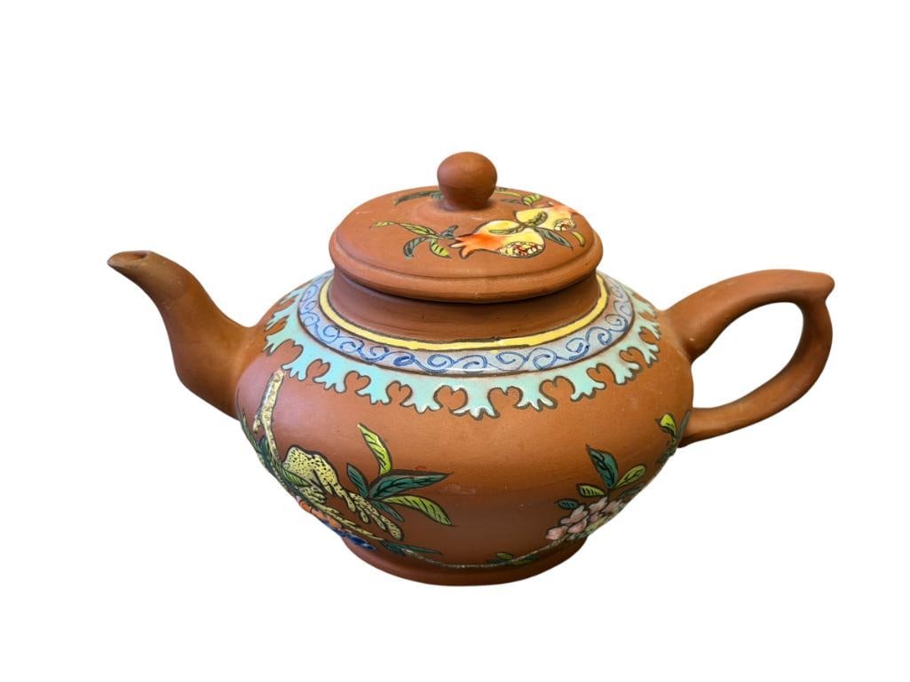 ANTIQUE CHINESE YIXING CLAY TEAPOT WITH ENAMELED BIRD AND FLORAL DESIGN: ROUND TEAPOT WITH COLORFUL ENAMELING, MARKED ON THE BOTTOM, NO DAMAGE OR REPAIRS 7" L