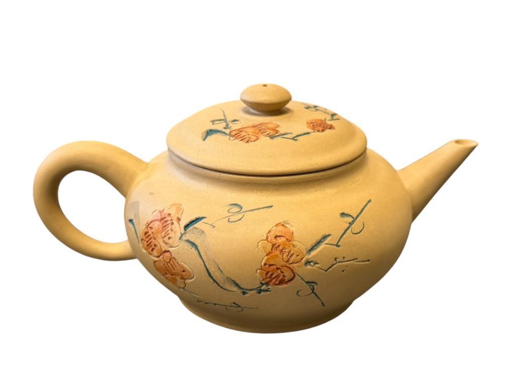 20TH CENTURY YIXING ZISHA CLAY TEAPOT WITH CALLIGRAPHY AND FLORAL DESIGN: INCISED AND HAND COLORED DESIGN, MARKED ON THE BOTTOM, NO CHIPS OR CRACKS 6" L