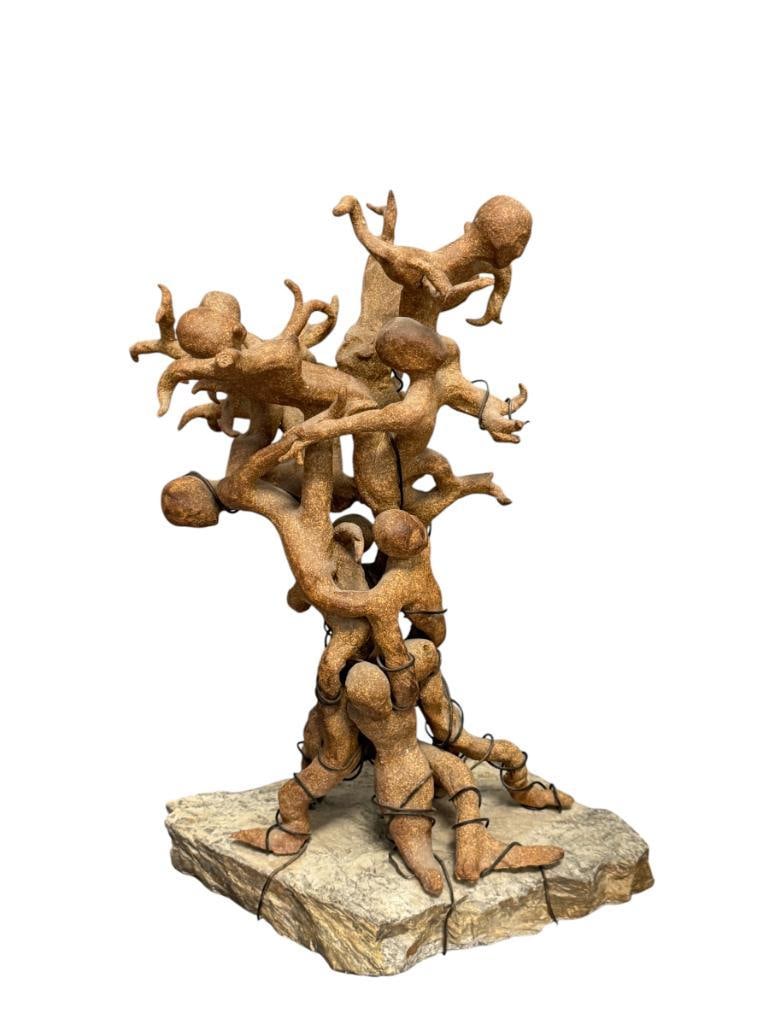 ABSTRACT CLAY SCULPTURE OF INTERTWINED FIGURES ON A ROUGH / NATURAL STONE BASE: SCULPTURE DEPICTS MULTIPLE INTERTWINED FIGURES MADE OF CLAY SECURED WITH METAL WIRE AND MOUNTED ON STONE BASE,NO SIGNATURE OR MARKINGS PRESENT 16 1/4" H
