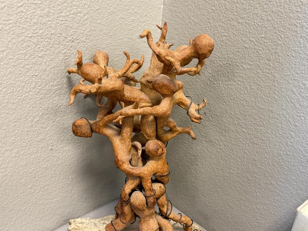 ABSTRACT CLAY SCULPTURE OF INTERTWINED FIGURES ON A ROUGH / NATURAL STONE BASE - 2