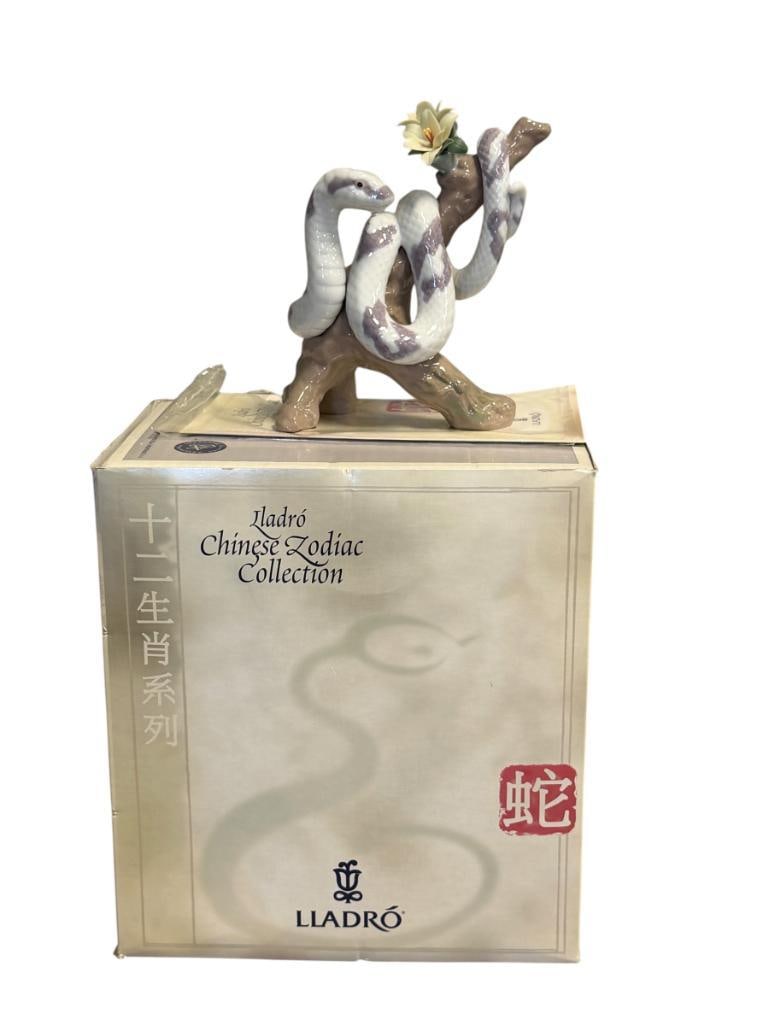 LLADRO ZODIAC COLLECTION FINE PORCELAIN FIGURE THE SNAKE NO. 01006780 DESIGNED BY JOAN CODERCH 2001: PART OF THE CHINESE ZODIAC COLLECTION, ISSUED IN 2001, MARKED ON THE BOTTOM, INCLUDES ORIGINAL BOX WITH SLEEVE, NO DAMAGE OR REPAIRS 6" H