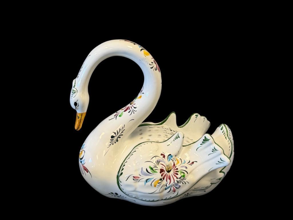 R.C. & CAL. HAND PAINTED PORTUGAL POTTERY SWAN PLANTER WITH COLORFUL MOTIF: FLORAL AND LEAF HAND PAINTED MOTIF, MARKED ON THE BOTTOM, FEATURES HOLES ON THE TOP OF THE BODY TO INSERT FLOWERS, NO CHIPS OR CRACKS 11 1/2" H 