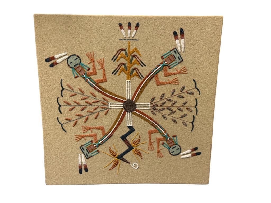 SIGNED NAVAJO SAND ART PAINTING TITLED RAINBOW PEOPLE: MADE FROM NATURAL COLORED SAND AND ROCK FORMATION, ART DEPICTS CENTRAL LIFE WITH RAINBOW FIGURES EXTENDING OUTWARD, SYMBOLIZING PEACE / UNITY / HEALING, SIGNED ON THE BACK BY THE ARTIST 12" X