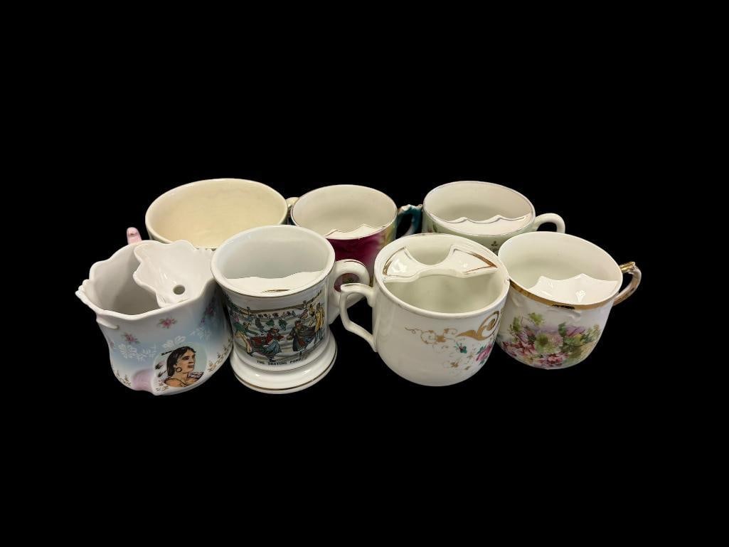 SIX VINTAGE MOUSTACHE CUPS AND MUG WITH FLORAL DESIGN AND GILT ACCENTS: FEW ARE MARKED ON THE BOTTOM, ONE CUP IS CHIPPED ON THE RIM APPROX 3 1/2" H