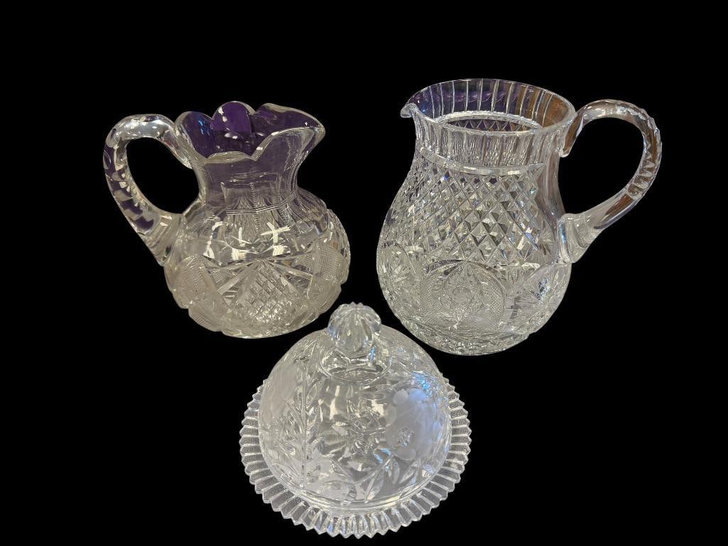 EARLY AMERICAN CUT CRYSTAL PITCHER AND EARLIER HOBSTAR CUT CRYSTAL PITCHER AND COVERED BUTTER DISH: HOBSTAR PATTERN PITCHER HAS "TINY" CHIP ALONG THE BODY 7" AND 7 1/2" PITCHERS