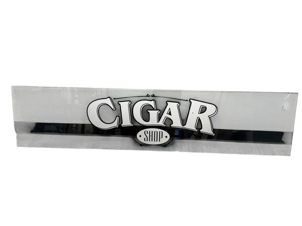 RECTANGULAR GLASS WINDOW WITH DECAL CIGAR SHOP IN GREY WITH BLACK OUTLINE: FEW MINOR CHIPS ALONG THE EDGES, NO CRACKS OR HEAVY SCRATCHES 70 1/2" X 16 1/4" 
