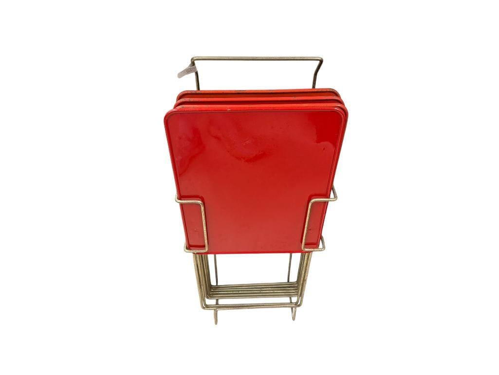 MID-CENTURY ENAMELED METAL TV DINNER TRAYS WITH CHROME ;LEGS AND CHROME FINISHED HOLDER: SET OF FOUR FOLDING TV DINNER TRAYS WITH RED TOPS, WEAR / PAINT WEAR PRESENT 15" X 12" X 21" 
