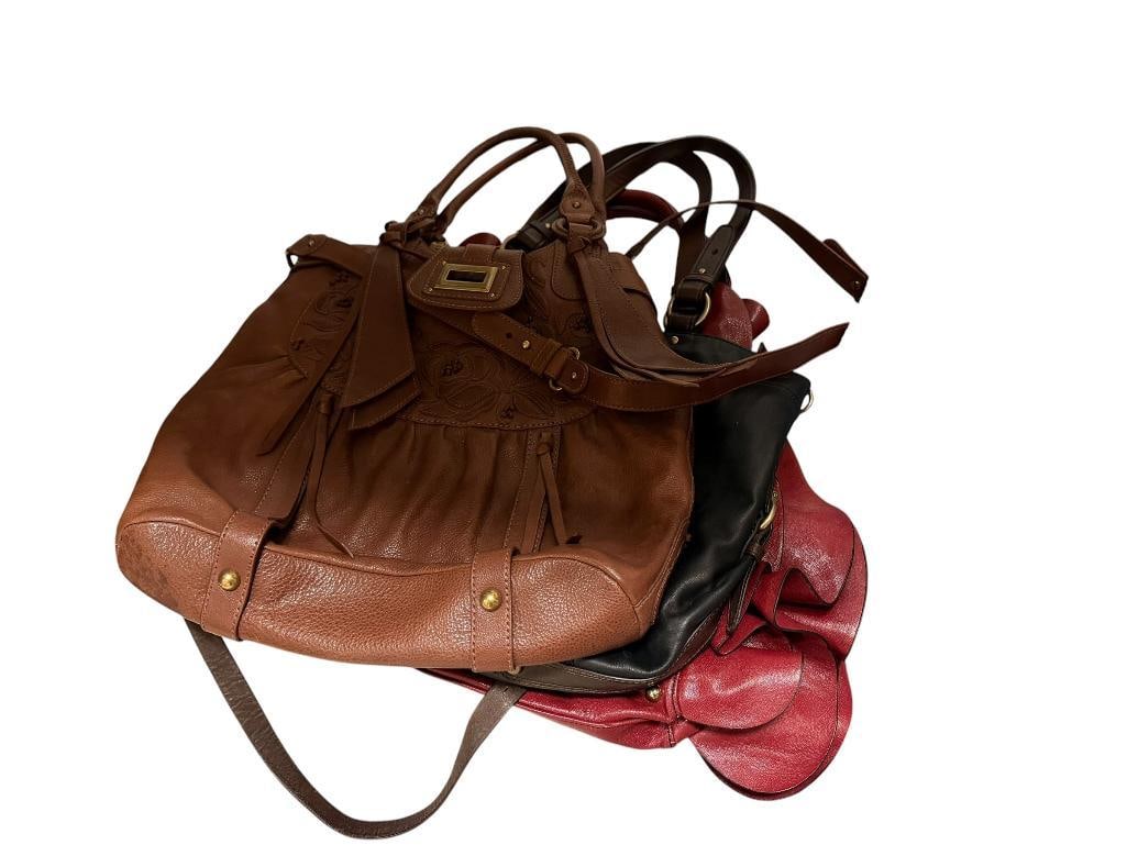 LADIES DESIGNER PURSES / HANDBAGS INCLUDING STEVE MADDEN RED GLAZED LEATHER WITH RUFFLES: ALSO INCLUDES COLE HAH TWO WAY TOTE LEATHER BAG AND LOCKHEART LIMITED EDITION # T019373 DESIGNER LEATHER PURSE, ALL IN PRETTY GOOD CONDITION LARGEST IS 15" X 5" X 12"