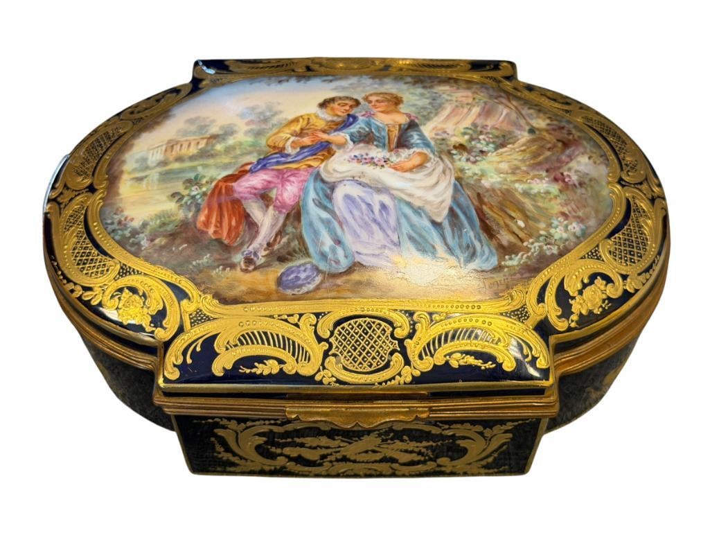 19TH CENTURY FENCH SEVRES-STYLE PORCELAIN JEWELRY BOX / CASKET / COFFRE HAND PAINTED FLORAL FOLIAGE: COBALT AND WHITE PORCELAIN JEWELRY BOX WITH HAND PAINTED HINGED TOP WITH ROMANTIC SCENE OF A MAN AND WOMAN WITH GILT FOLIAGE,ORMULU TRIM, SIGNED HENRY, INTERIOR IS IS ALSO HAND PAINTED WITH FLOWERS, M
