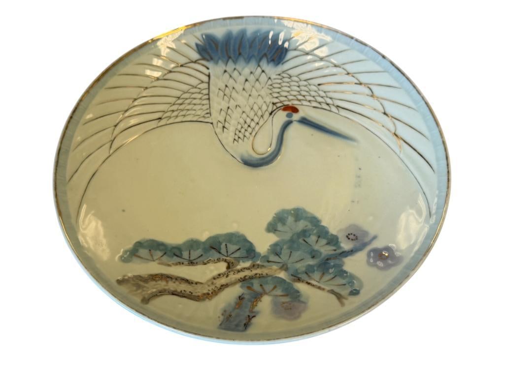 MID-CENTURY DAINAN CELADON GLAZE PORCELAIN PLTE WITH HANDPAINTED RED-CROWNED CRANE AND GITL ACCENTS: GILDING ON THE EDGE AND FEATHERS DO SHOW SOME WEAR, MARKED ON THE BOTTOM, MADE IN JAPAN, NO DAMAGE OR REPAIRS 9 3/4" ROUND