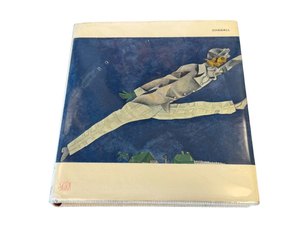 1956 FIRST EDITION CHAGALL BOOK WITH TIPPED COLOR PLATES PUBLISHED BY EDITIONS D'ART ALBERT SKIRA: INCLUDES 53 COLOR PLATES, 5 PAGES DO HAVE SLIGHT DAMAGE, DUST JACKET INCLUDED 6 5/8" X 7 1/8" 