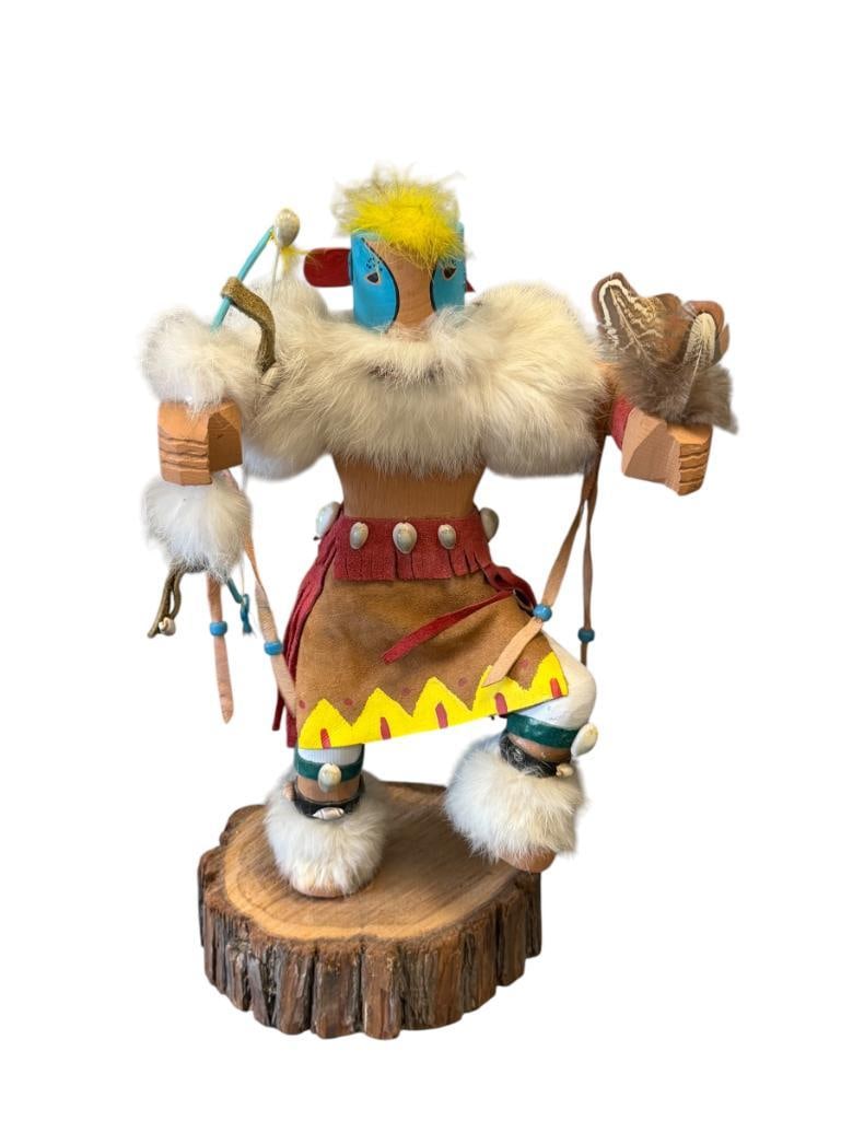 DIANE HAND CRAFTED NATIVE AMERICAN LIZARD KACHINA DOLL: COTTONWOOD CARVED KACHINA DOLL MOUNTED ON WOOD SLAB, DECORATED WITH SUEDE, BEADS, SEA SHELLS, ANIMAL FUR, FEATHERS AND ALSO HAND PAINTED,MISSING AN EAR PIECE, SIGNED ON THE BOTTOM 15 1/4" H